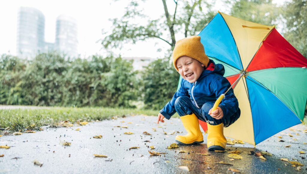 Happy laughing child with colorful umbrella